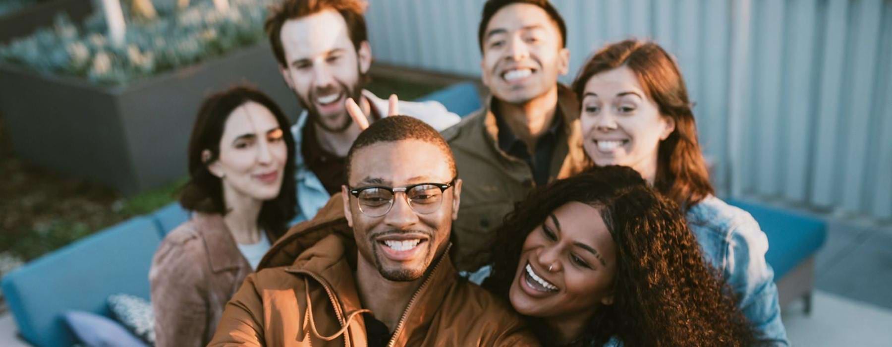 friends take a group selfie outdoors